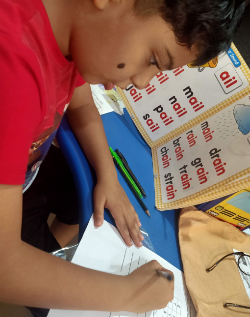 Lishaan working with Montessori grammar material