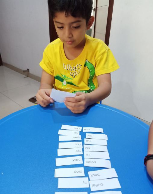 Lishaan working with Montessori grammar material