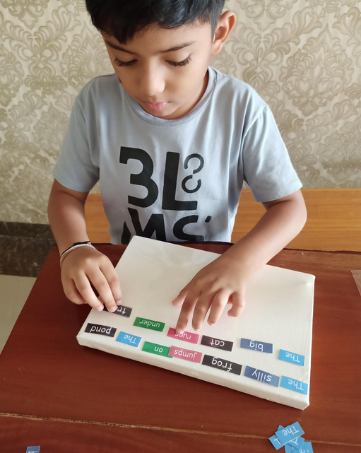 Lishaan working with Montessori grammar material